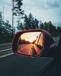 Close-up of sunglasses on side-view mirror