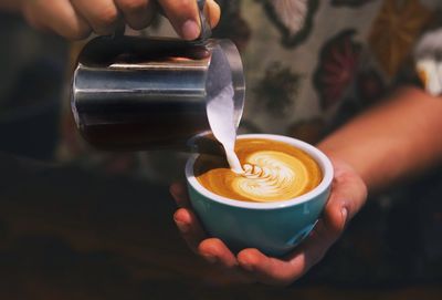 Cropped image of hand holding coffee cup