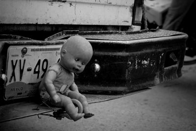 Close-up of boy playing with toy car