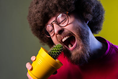 Man wearing eyeglasses eating cactus