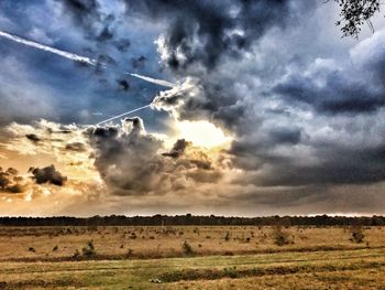 Scenic view of field against sky during sunset