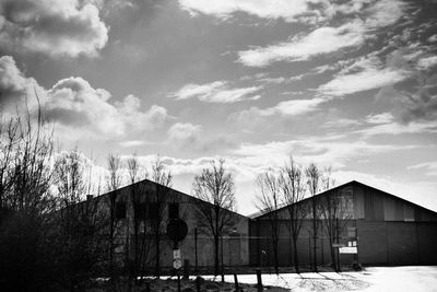 Houses against cloudy sky