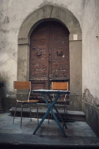 Empty chairs and table in old building