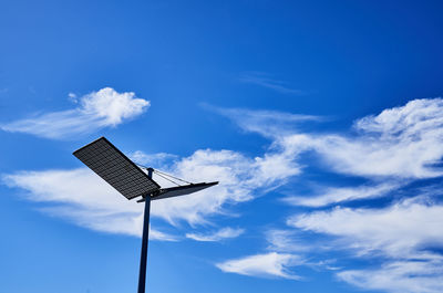 Low angle view of solar battery against blue sky