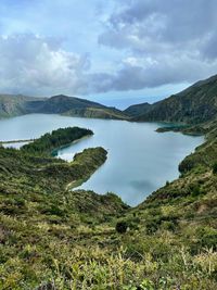 Scenic view of lake and mountains against sky