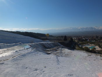 Scenic view of snowcapped mountains against blue sky