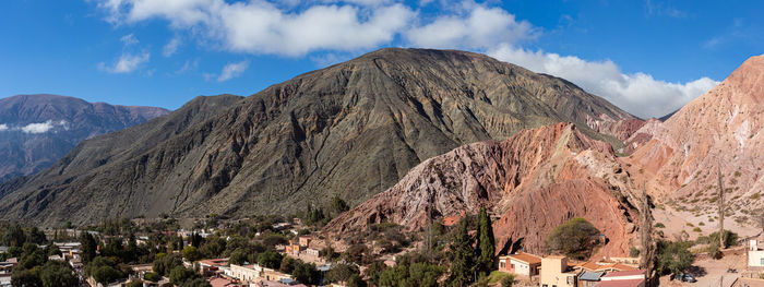 Panoramic view of trees and mountains against sky