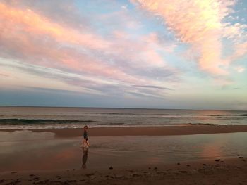 Scenic view of beach against sky during sunset