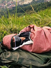 High angle view of man relaxing on field