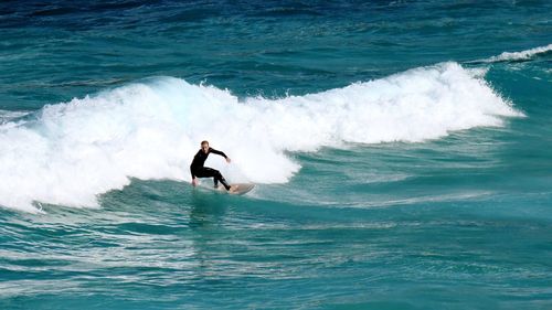 People surfing in sea