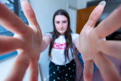 Close-up portrait of a woman standing in a hand