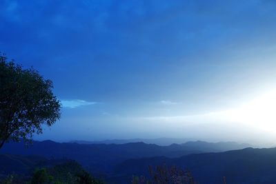 Scenic view of mountains against blue sky