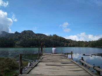 Pier over lake against sky