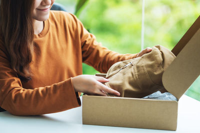 Midsection of woman using laptop