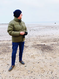 Full length of young man standing on beach