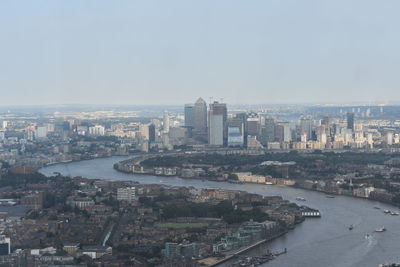 High angle view of river amidst buildings in city against sky