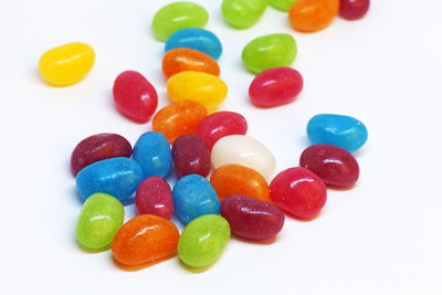 High angle view of multi colored candies on white background