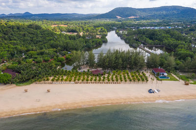 High angle view of lake by trees against sky