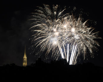 Low angle view of firework display at night