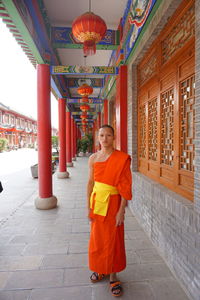 Portrait of man standing in temple against building