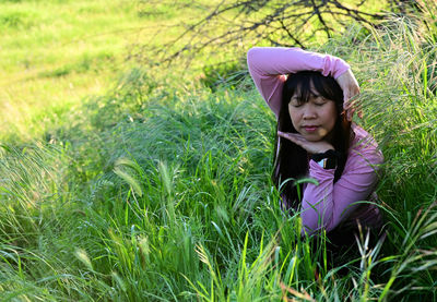 Happy girl on grass in field