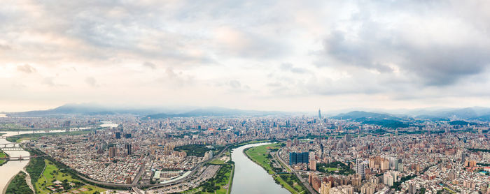 High angle view of illuminated city buildings against sky