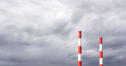 Low angle view of smoke stack against sky