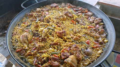 High angle view of vegetables in cooking pan. paella