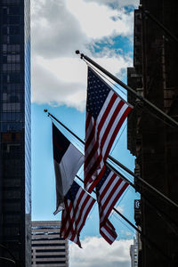 Low angle view of flag against buildings in city