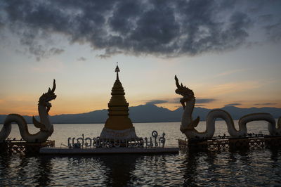 Silhouette of statues at sunset