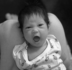 Portrait of cute baby boy yawning
