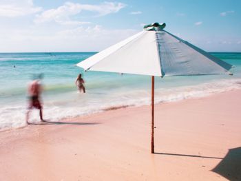 People on beach against sky