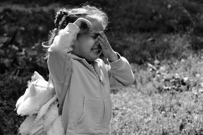 Cute girl crying while standing outdoors