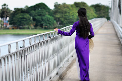 Rear view of woman standing in park