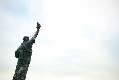 Low angle view of statue of liberty against sky