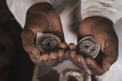 An egyptian beduin man holding a quartz gemstone he found in the high mountains of sinai in egypt