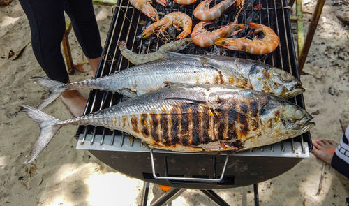 High angle view of fish on barbecue grill