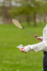 Midsection of man playing tennis