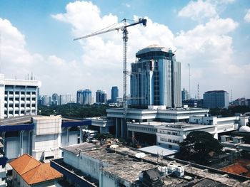 Buildings against cloudy sky