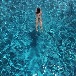 High angle view of woman swimming in pool