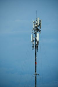 Low angle view of communications tower against sky