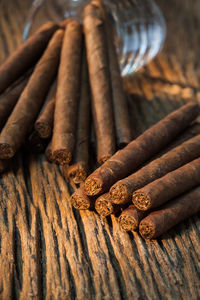 Close-up of cigars on wooden table