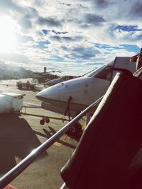 View of airplane at airport runway against sky