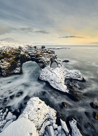 Wonderful seascape of rocky seashore during sunset in winter