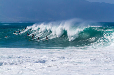 High angle view of people surfing in sea