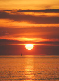 Scenic view of sea against romantic sky at sunset