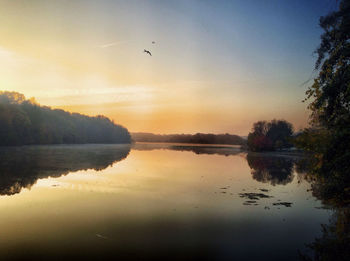 Scenic view of calm lake at sunset