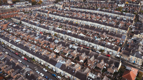 An aerial view above the rooftops of  terraced houses on a residential estate in the north england