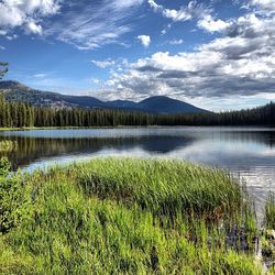 Scenic view of lake against cloudy sky