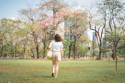 Rear view of woman walking at park